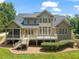 Backyard features a spacious deck, screen porch, lush lawn, and mature trees, ideal for relaxation and entertaining at 3728 Westbury Lake Dr, Raleigh, NC 27603