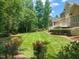 Expansive backyard with lush green lawn and mature trees, perfect for outdoor activities at 3728 Westbury Lake Dr, Raleigh, NC 27603