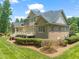 Exterior of a brick house with a manicured lawn and a deck at 3728 Westbury Lake Dr, Raleigh, NC 27603