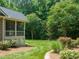 Backyard view featuring a screened-in porch and landscaped yard at 3728 Westbury Lake Dr, Raleigh, NC 27603