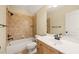 Well-lit bathroom with a tile surround tub and vanity at 3728 Westbury Lake Dr, Raleigh, NC 27603