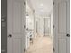 En suite bathroom featuring dual sinks, a vanity, tile floors, and access to the shower and tub at 3728 Westbury Lake Dr, Raleigh, NC 27603