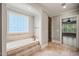 Relaxing bathroom showcasing a garden tub with tile surround and a glass block window for natural light at 3728 Westbury Lake Dr, Raleigh, NC 27603