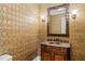 Elegant powder room featuring decorative wallpaper, ornate mirror, and vanity at 3728 Westbury Lake Dr, Raleigh, NC 27603