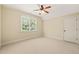 Bright, carpeted bedroom with a ceiling fan and a window view at 3728 Westbury Lake Dr, Raleigh, NC 27603