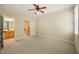 Bright bedroom featuring neutral carpet and doorway view into the staircase and vanity at 3728 Westbury Lake Dr, Raleigh, NC 27603