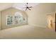 Upstairs bedroom with a vaulted ceiling, ceiling fan and a wall of windows offering scenic backyard views at 3728 Westbury Lake Dr, Raleigh, NC 27603