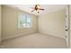 Cozy carpeted bedroom with a ceiling fan and a bright window view at 3728 Westbury Lake Dr, Raleigh, NC 27603