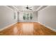 Bedroom with a trey ceiling, a ceiling fan, hardwood floors and several windows providing natural light at 3728 Westbury Lake Dr, Raleigh, NC 27603