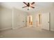 Bright bedroom featuring neutral carpet, open doors, and access to a bathroom and hallway at 3728 Westbury Lake Dr, Raleigh, NC 27603