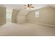 Versatile bonus room with neutral carpet, ceiling fan, and natural light from two windows at 3728 Westbury Lake Dr, Raleigh, NC 27603