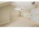 Expansive bonus room with neutral carpet, ceiling fan, and natural light for versatile use at 3728 Westbury Lake Dr, Raleigh, NC 27603