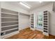 Large walk in closet with custom shelving and hardwood floors for maximum organization at 3728 Westbury Lake Dr, Raleigh, NC 27603