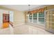 Bright dining room with tile flooring, large windows, and access to butler's pantry at 3728 Westbury Lake Dr, Raleigh, NC 27603