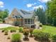 Beautiful home exterior featuring a screened-in porch, two-car garage and landscaped yard at 3728 Westbury Lake Dr, Raleigh, NC 27603