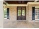 Inviting front entrance with brick facade, double doors, and charming window shutters at 3728 Westbury Lake Dr, Raleigh, NC 27603