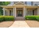Charming front porch with brick accents and a well-manicured garden, creating a welcoming entrance at 3728 Westbury Lake Dr, Raleigh, NC 27603