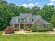 Stately home boasts manicured lawn, lush landscaping, and a welcoming front porch, creating great curb appeal at 3728 Westbury Lake Dr, Raleigh, NC 27603