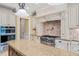 Gourmet kitchen featuring custom cabinetry, granite countertops, and stainless steel appliances for a chef-inspired space at 3728 Westbury Lake Dr, Raleigh, NC 27603