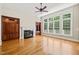Bright living room with hardwood floors, large windows offering great views, built-in bookshelves, and a fireplace at 3728 Westbury Lake Dr, Raleigh, NC 27603