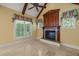 Cozy living room featuring a fireplace, tile flooring, and natural light at 3728 Westbury Lake Dr, Raleigh, NC 27603