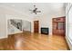 Open-concept living room featuring hardwood floors, fireplace, built-in bookshelves, and staircase access at 3728 Westbury Lake Dr, Raleigh, NC 27603