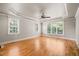 Spacious bedroom with hardwood floors, tray ceiling, large windows offering abundant natural light, and great views at 3728 Westbury Lake Dr, Raleigh, NC 27603