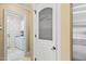 View of the pantry door and the laundry room featuring a washer, dryer and patterned wallpaper at 3728 Westbury Lake Dr, Raleigh, NC 27603