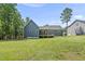Back exterior of the house with a porch and a large yard at 374 Heart Pine Dr, Wendell, NC 27591