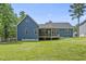 Back exterior of the house with a porch and a large yard at 374 Heart Pine Dr, Wendell, NC 27591