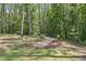Landscaped backyard area with seating in a wooded area at 374 Heart Pine Dr, Wendell, NC 27591