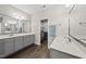 Bright bathroom with dual vanity, quartz countertops and a laundry room at 374 Heart Pine Dr, Wendell, NC 27591