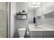 Clean bathroom featuring a toilet, sink, mirror, and decorative shelves with plants at 374 Heart Pine Dr, Wendell, NC 27591