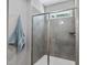 Close up of a modern tiled shower featuring glass doors and a window at 374 Heart Pine Dr, Wendell, NC 27591
