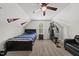 Finished bedroom with a bed, nightstand, exercise equipment, and sofa beneath an attic ceiling at 374 Heart Pine Dr, Wendell, NC 27591