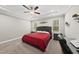 Primary bedroom with a tray ceiling, ceiling fan, two windows, and desk at 374 Heart Pine Dr, Wendell, NC 27591