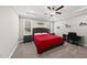 Primary bedroom with tray ceilings, a ceiling fan, and two windows at 374 Heart Pine Dr, Wendell, NC 27591