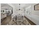 Charming dining area with modern lighting fixtures, view of the open-concept kitchen and living space at 374 Heart Pine Dr, Wendell, NC 27591
