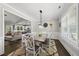 Cozy dining area with wood table, chairs, and view of the open-concept kitchen and living space at 374 Heart Pine Dr, Wendell, NC 27591