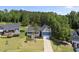 Two-story blue home with a well-maintained lawn and two-car garage, surrounded by lush trees at 374 Heart Pine Dr, Wendell, NC 27591