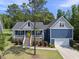 Charming blue two-story home with welcoming front porch and landscaped front yard at 374 Heart Pine Dr, Wendell, NC 27591