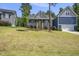 Charming home featuring a welcoming front porch, bright yellow front door and a well-manicured lawn at 374 Heart Pine Dr, Wendell, NC 27591