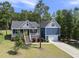 Lovely two-story blue home featuring a manicured lawn, attractive landscaping, and a two-car garage at 374 Heart Pine Dr, Wendell, NC 27591