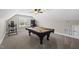 Finished game room with a pool table, an arcade game, and exercise equipment beneath an attic ceiling at 374 Heart Pine Dr, Wendell, NC 27591