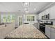 Spacious kitchen with granite countertops and views to the outdoor deck at 374 Heart Pine Dr, Wendell, NC 27591