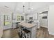 Bright kitchen featuring an island, stainless appliances, and white countertops at 374 Heart Pine Dr, Wendell, NC 27591