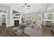 Inviting living room featuring a cozy fireplace, comfortable seating, and open access to the kitchen at 374 Heart Pine Dr, Wendell, NC 27591