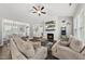 Inviting living room with vaulted ceilings, a fireplace and comfortable sofas at 374 Heart Pine Dr, Wendell, NC 27591