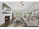Bright living room with fireplace, comfortable seating, open to modern kitchen, and plenty of natural light at 374 Heart Pine Dr, Wendell, NC 27591