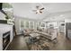 Spacious living room with vaulted ceiling, fireplace, large windows, and open-concept kitchen at 374 Heart Pine Dr, Wendell, NC 27591